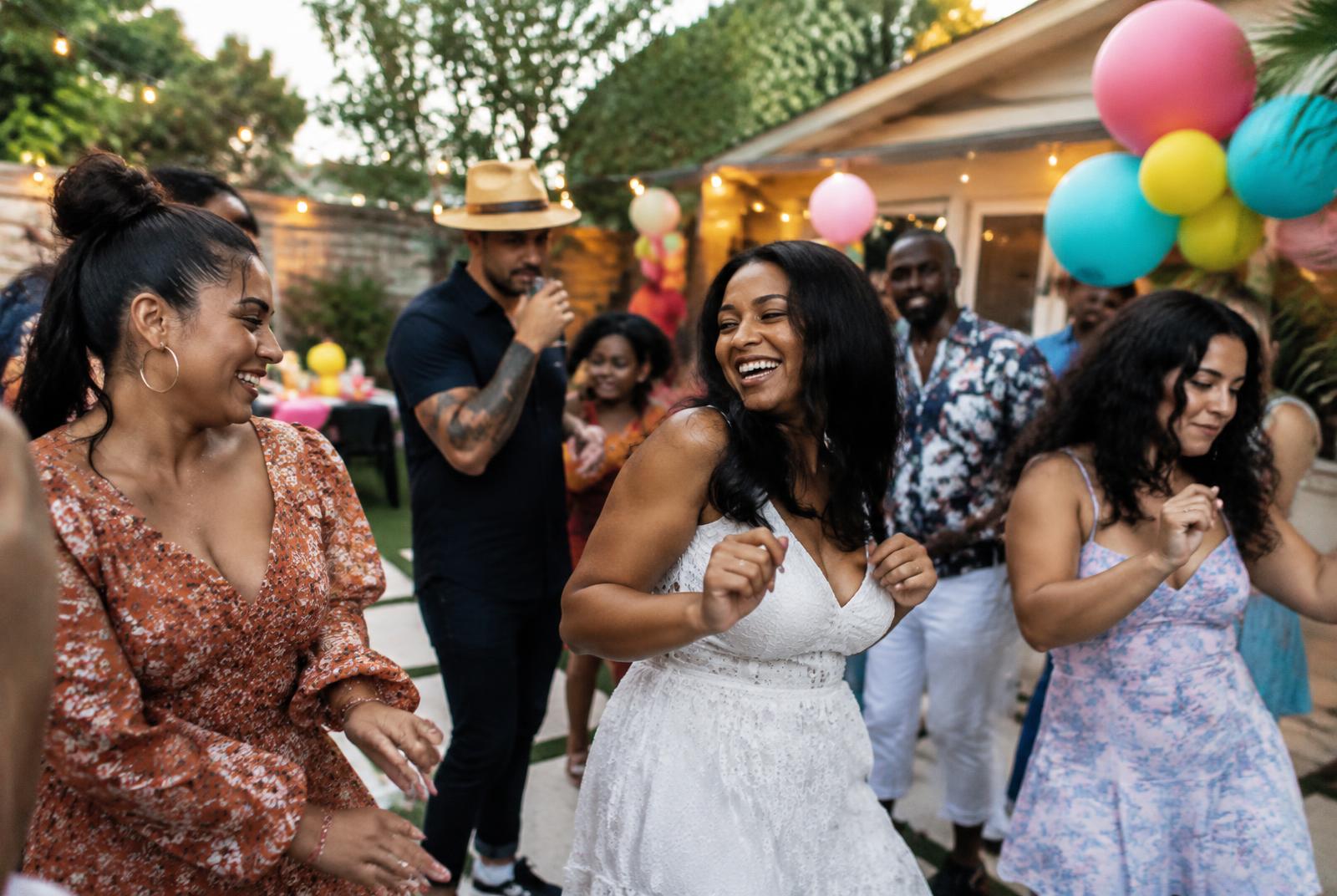Guests dancing at a backyard birthday party